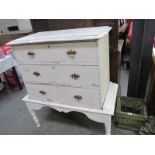 A white painted 3 drawer chest on legs