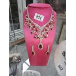 A decorative necklace and earrings (stand not included)