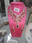 A decorative necklace and earrings (stand not included)