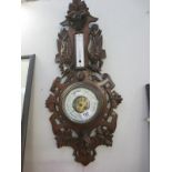 A French barometer featuring a wolf's head and birds