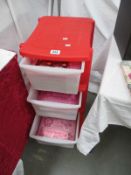 A quantity of craft items in a 4 drawer storage container