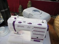 A Gemini Stitch machine (as new) and a box of sewing related items
