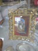 A gilt framed picture of a child