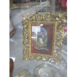 A gilt framed picture of a child