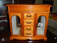 A pine 4 drawer 2 door jewllery box and contents
