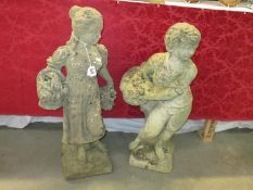 2 garden statues, both carrying baskets,
