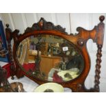 An ornate wooden over mantel mirror