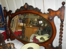 An ornate wooden over mantel mirror