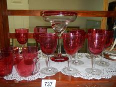 A quantity of cranberry coloured glassware