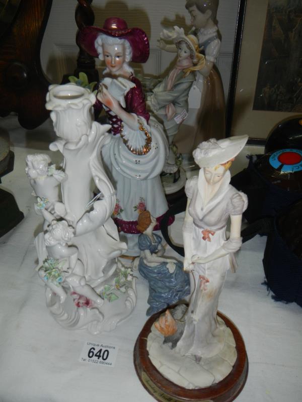 3 figurines and a figural china candlestick