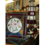 A mosaic glass tile and other glass items including lighthouse