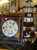 A mosaic glass tile and other glass items including lighthouse
