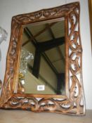 A carved wooden framed mirror