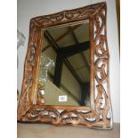 A carved wooden framed mirror