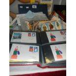 A mixed lot of stamps and cigarette cards including First Day Covers, Commemorative, Players,