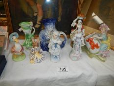 A collection figurines including Beatrix Potter