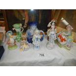 A collection figurines including Beatrix Potter