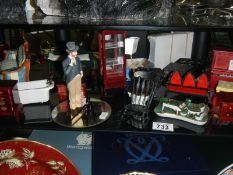 A shelf of miniatures and dolls house items
