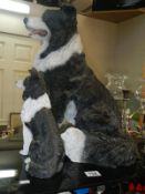 A large figure of a Border Collie and a smaller figure