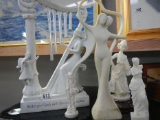 A collection of figures including lady playing harp