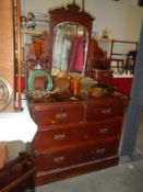 A mirror backed chest of drawers dresser