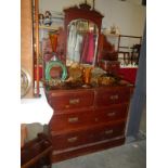 A mirror backed chest of drawers dresser