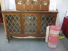 An astragal glazed 3 door display cabinet