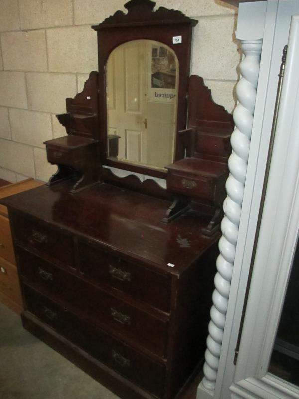 A mirror backed chest of drawers