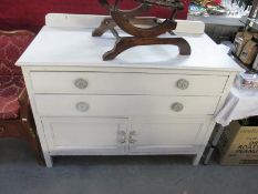 A white painted 2 drawer chest with bottom cabinet