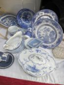 A collection of blue and white china including Old Willow and Wedgwood