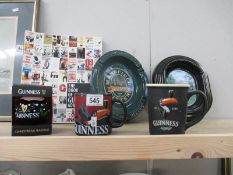 A boxed Guinness bauble and 2 Guinness mugs/cups and Guinness advertising book and 2 pub ashtrays