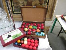 A wooden boxed set of snooker balls with chalk and a set of Guinness Brother snooker balls