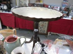 An oval tripod table