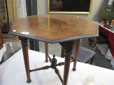 An octagonal table with x-form cross stretcher