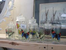 A collection of painted jars featuring butterflies