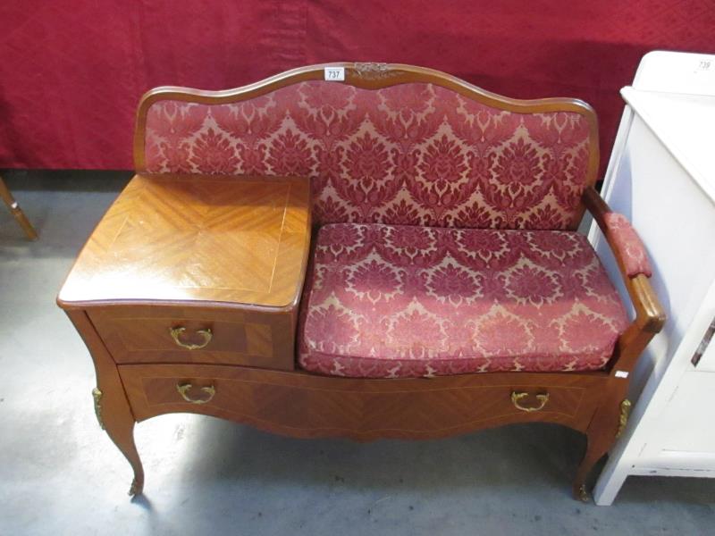 A telephone table with drawer and upholstered seat