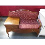 A telephone table with drawer and upholstered seat