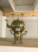 An ornate brass tea kettle on stand A/F