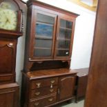 A glazed top dresser having one cupboard and 3 drawers.