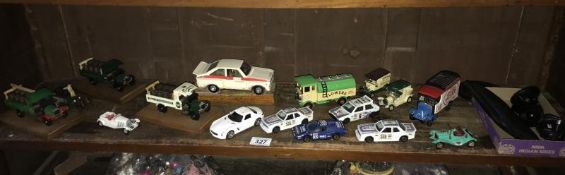 A shelf of diecast cars etc.