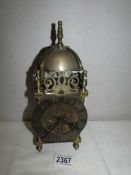 A brass lantern clock.