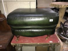 A green leather foot stool pouffe