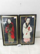 2 silk portraits depicting a Japanese man and woman.