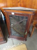 A glazed corner cupboard.