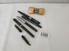 A quantity of pens including Platinum and Shaefer together with a small travel clock.