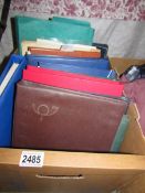 A box of stamp albums and stamps.