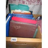 A box of stamp albums and stamps.