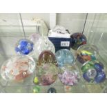 11 assorted glass paperweights.