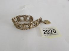 A 9ct gold bracelet with 9ct gold padlock, approximately 14 grams.