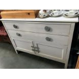 A white painted shabby chic chest of drawers with cupboards